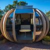 garden pods - photo of a big graden pod with glass, seats and a table.