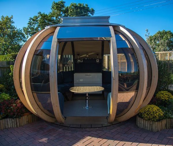 garden pods - photo of a big graden pod with glass, seats and a table.