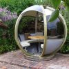 garden pods - photo of rotating seater garden pod with table and glass walls.