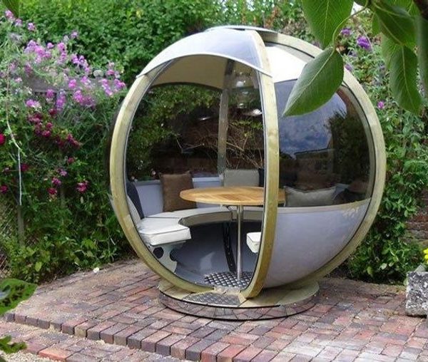 garden pods - photo of rotating seater garden pod with table and glass walls.